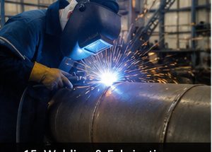 Welder working on industrial pipe
