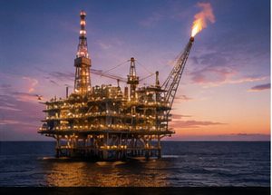 Offshore oil and gas platform at sunset